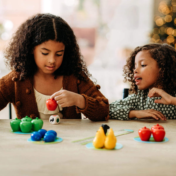 Children playing HABA First Orchard with colorful wooden fruit at a table