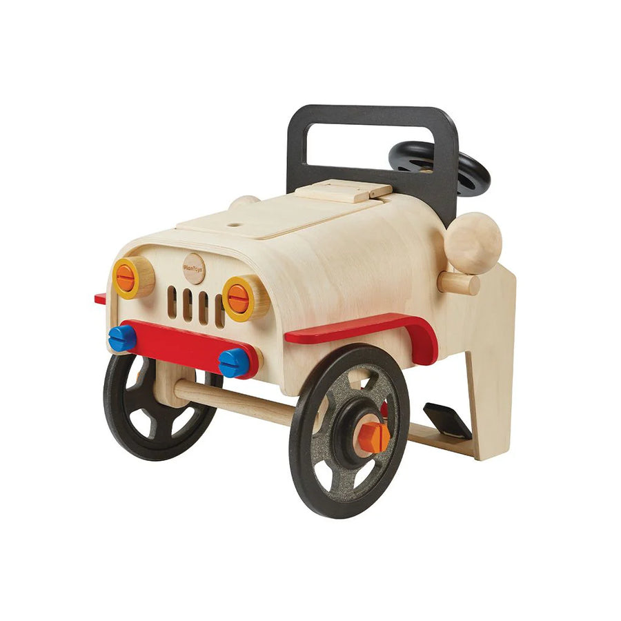 PlanToys Motor Mechanic toy with a car-front design, wheels and a steering wheel.