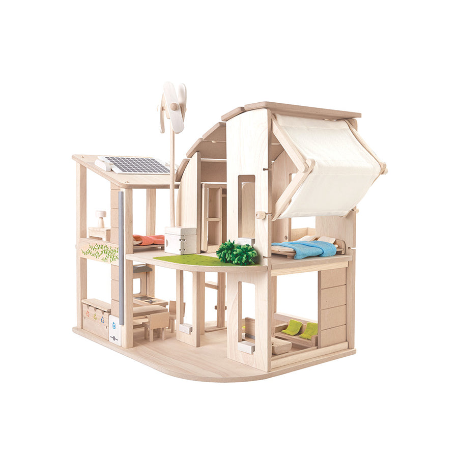 Open wooden PlanToys dollhouse with furnished rooms, a wind turbine and roof panel.