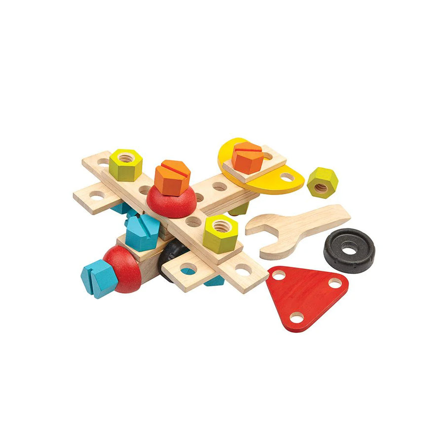 PlanToys construction pieces with wooden strips, colorful nuts, wheels and a toy wrench.