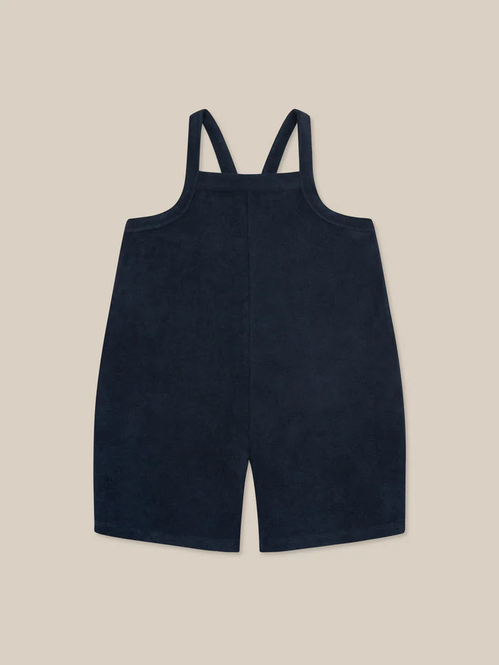Navy Organic Zoo cropped dungarees with shoulder straps and a square bib.