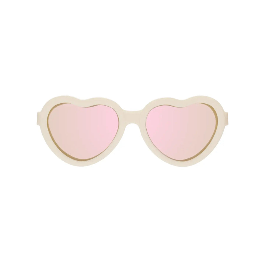 Cream heart-shaped Babiators sunglasses with pink mirrored lenses.
