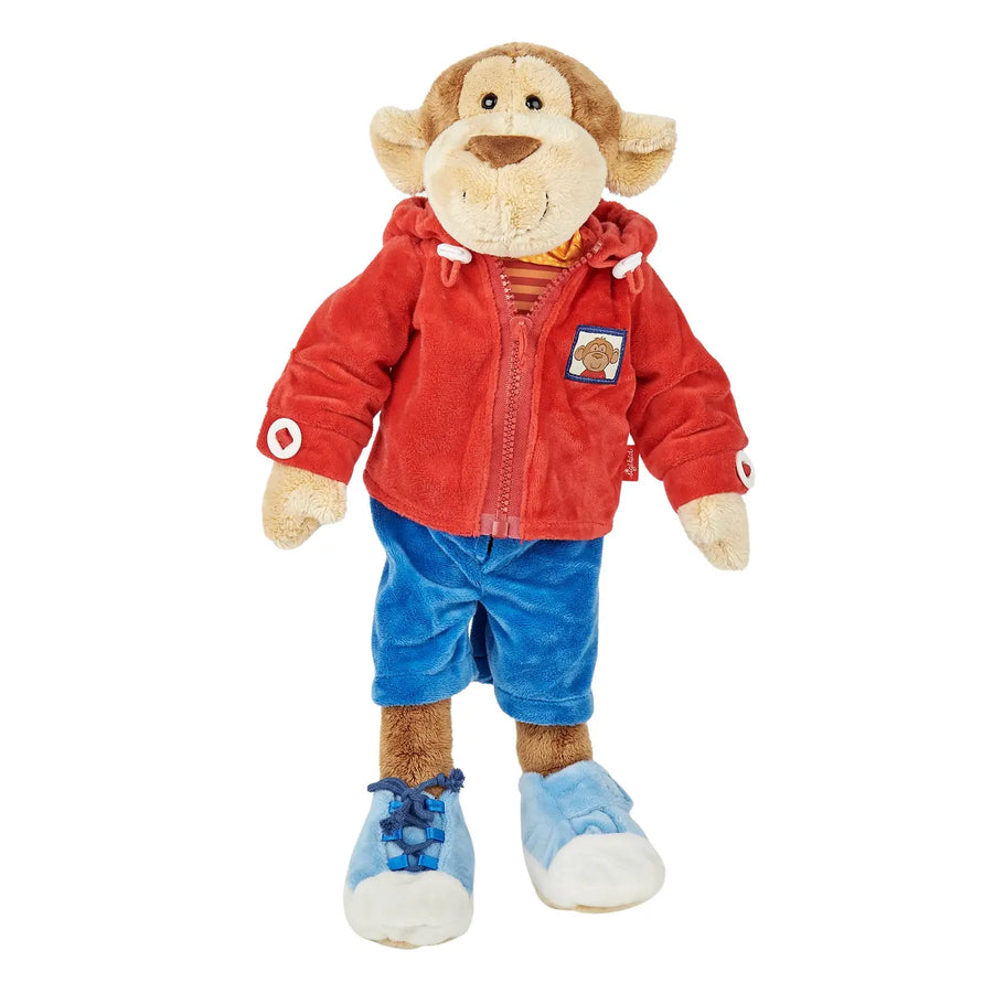 sigikid Teaching Monkey plush wearing a red jacket, blue trousers and lace-up shoes.