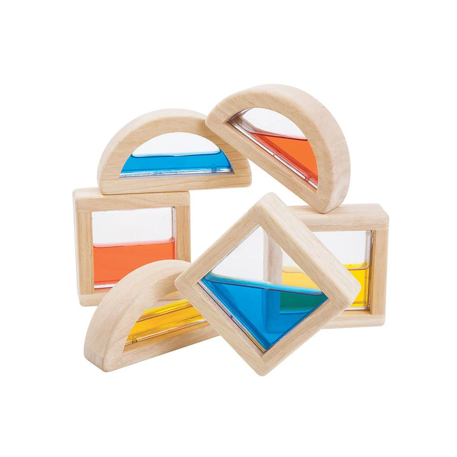 PlanToys wooden geometric blocks with transparent windows filled with colored liquid.