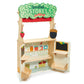 Tender Leaf Woodland Stores and Theater stand with a leafy sign, red curtain and side chalkboard.