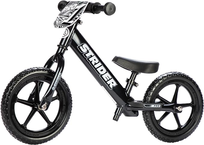 Black Strider 12 Pro balance bike shown from the side, with a low seat and no pedals.