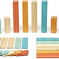 Forty-two Tegu Sunset wooden blocks and wheels displayed by shape and color.