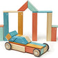 Tegu Sunset blocks arranged into an archway behind a small wheeled car.