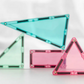 Pastel CONNETIX triangular and square tiles standing upright on a white surface.
