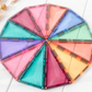 Pastel CONNETIX triangular tiles arranged into a multicolored circle.