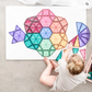 Child arranging pastel CONNETIX tiles into a flat flower pattern.
