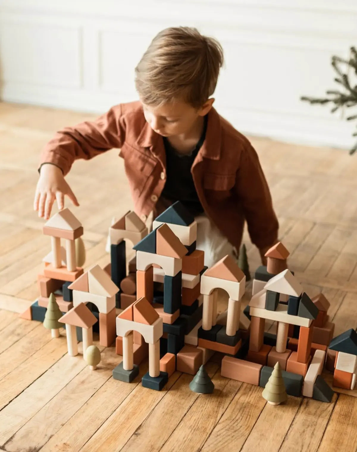 Child building an imaginative wooden block town